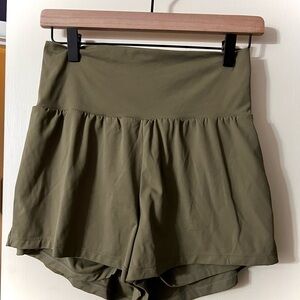 New Halara “Withered Green” Yoga Shorts. High, flat waist, hidden pocket. Medium